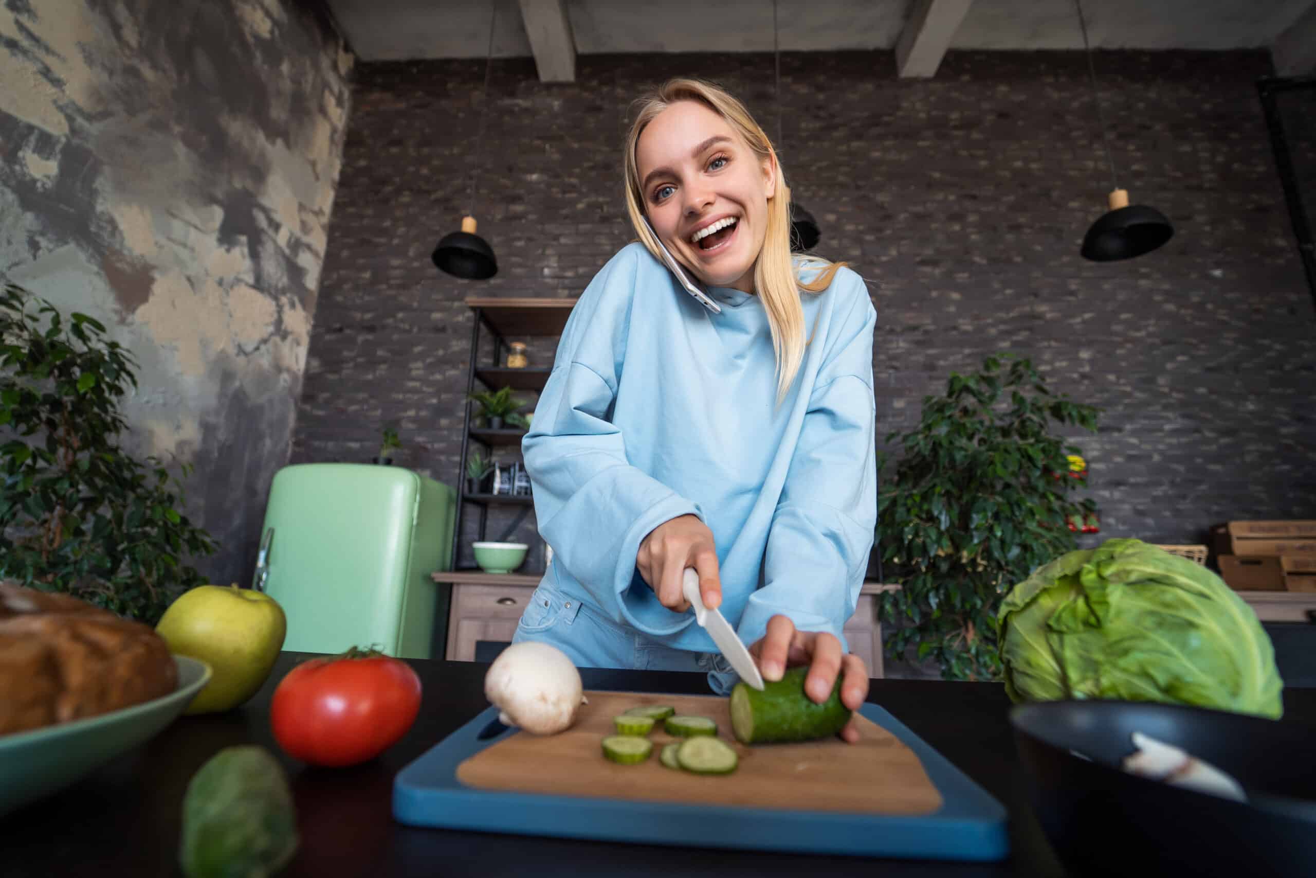 Beautiful girl talking on the mobile phone in kitchen at home Despre mine